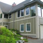 Hardi Panel siding with stained Western Red Cedar trim updates the exterior.  Yellow Cedar siding was used at the entryway.
